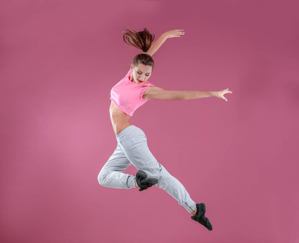Hip hop dancer dancing on pink background - Φωτογραφία, εικόνα