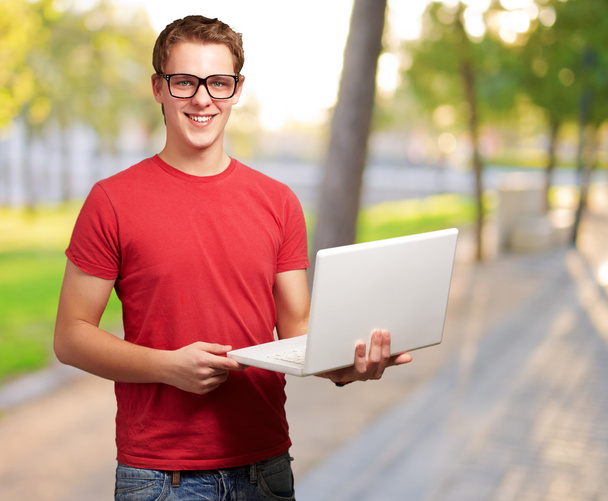 Portrait Of A Young Man Holding A Laptop - Fotó, kép