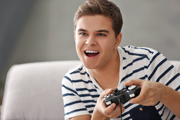 Teenager playing videogame - Fotó, kép