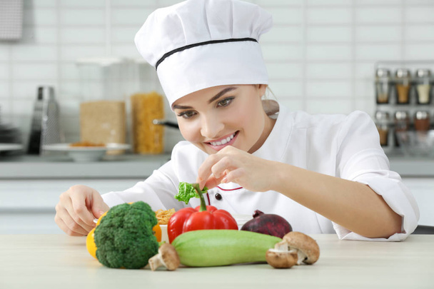 Young woman chef with set of vegetables on table - Foto, Bild