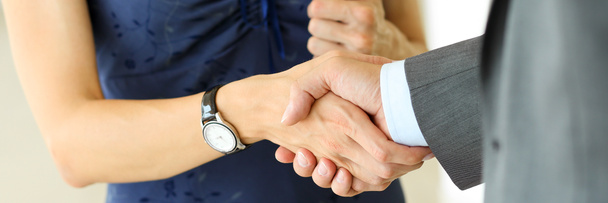 Businessman and woman shake hands as hello in office closeup - Photo, Image