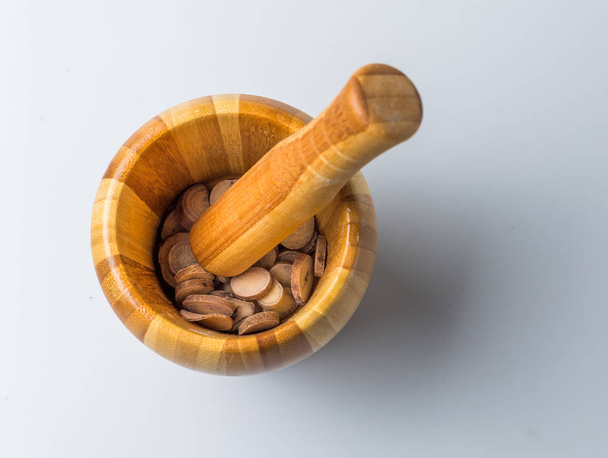 Chinese Herbal Medicine in a pestle on the table - Фото, зображення
