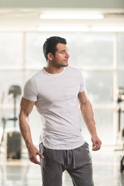Strong Man in White T-shirt Background Gym - Foto, Imagen