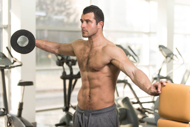 Hairy Man With Dumbbells Exercising Shoulders - Photo, Image