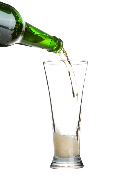 Beer pouring from green bottle into glass isolated on white - Foto, immagini
