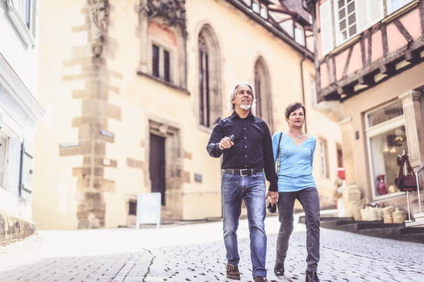 Senior Couple Walking Through The Streets Of Tuebingen - 写真・画像