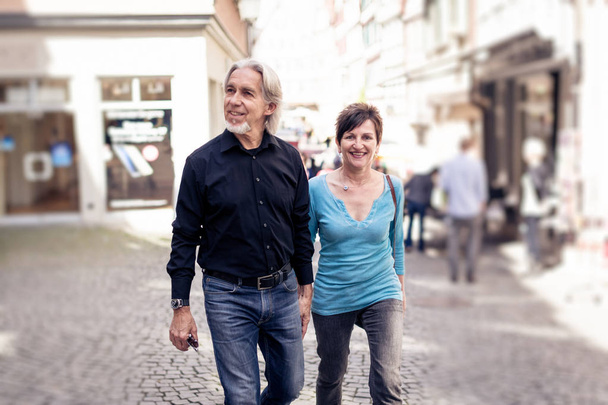 Senior Couple Walking Through The Streets Of Tuebingen - 写真・画像