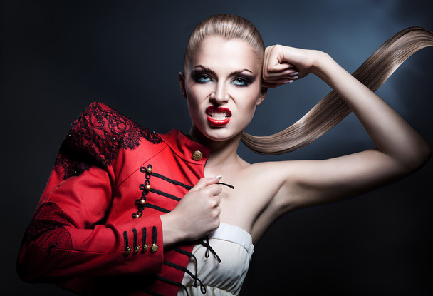 aggressive blonde woman in red - Φωτογραφία, εικόνα