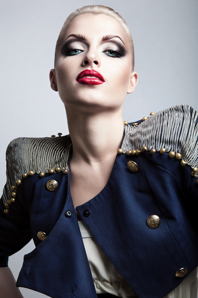 close-up portrait of blonde woman in blue jacket with red lips - Фото, зображення