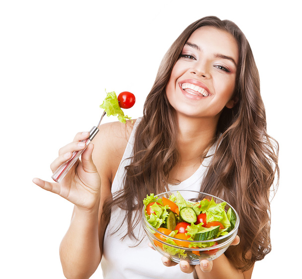 Hungry beautiful healthy woman holding salad - 写真・画像