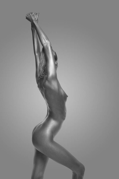 naked body in a silver body painting - Foto, Imagen
