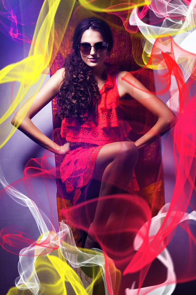 brunette woman in sunglasses and red dress around fabric - Zdjęcie, obraz