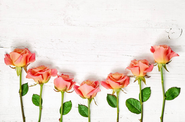 pink roses on white wooden table - Foto, Imagem