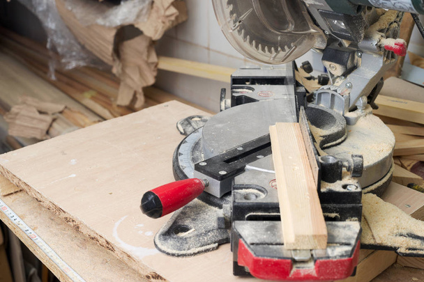 Carpenter tools on wooden table with sawdust. Circular Saw. - Photo, Image