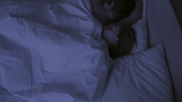 concept of insomnia, the couple tosses in his sleep, a top view - Video