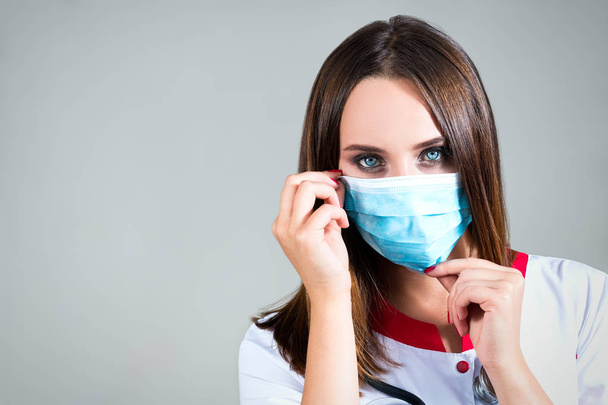 woman doctor, nurse eyes, wears a gauze mask with space for text - Фото, зображення