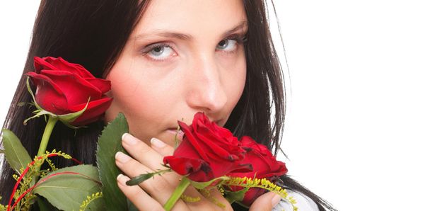 Closeup portrait of attractive young woman holding a red rose - Photo, image