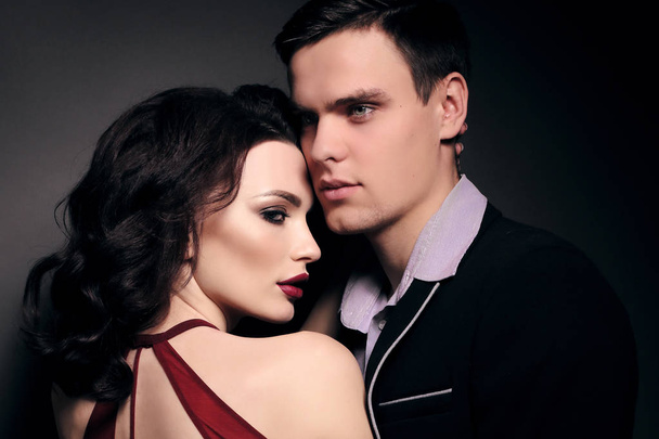 fashion studio photo of lovely impassioned couple in elegant out - Fotó, kép