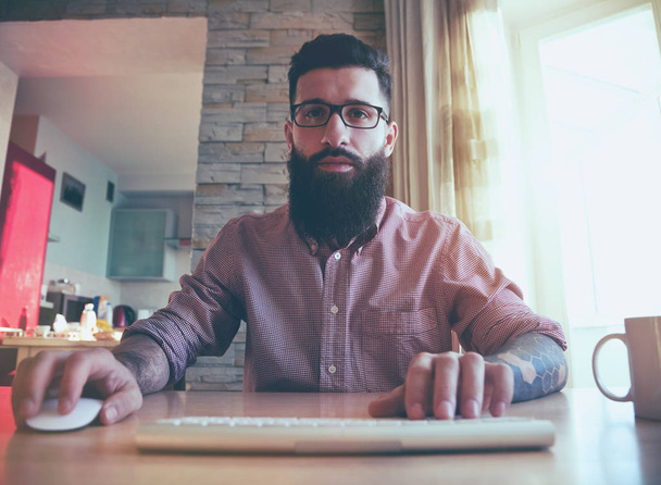 bearded man working with computer at home as freelancer - Zdjęcie, obraz