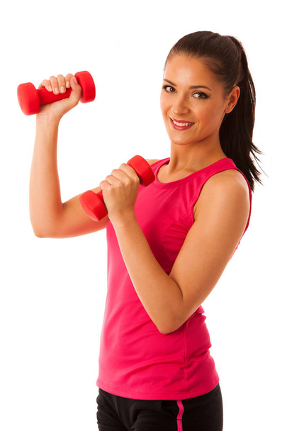 Active young woman workout with dumbbells in fitness gym isolated over white background - Фото, зображення