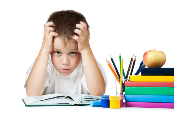 Sad schoolboy is doing his homework - Fotografie, Obrázek