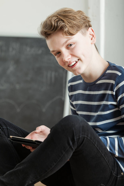 Charismatic young boy using a tablet - Foto, Bild