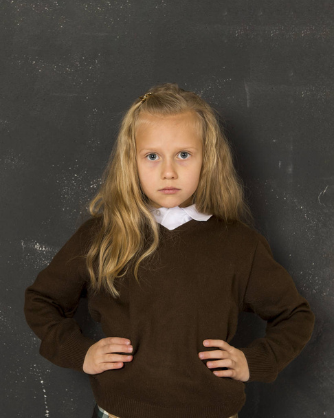  beautiful blond schoolgirl sad moody and tired in front of school class blackboard - Photo, Image
