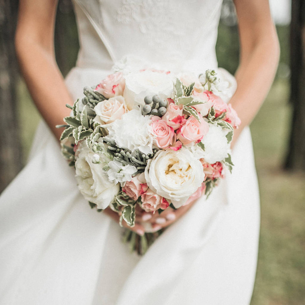 Beautiful wedding bouquet in bride's hands - 写真・画像