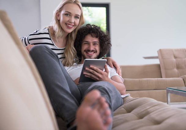 couple relaxing at  home with tablet computers - Фото, зображення