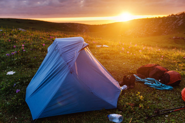 Подсвеченная солнечным светом голубая палатка в кемпинге
 - Фото, изображение