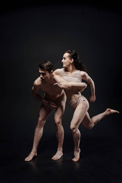 Muscular gymnasts performing together in the studio - Foto, Imagem