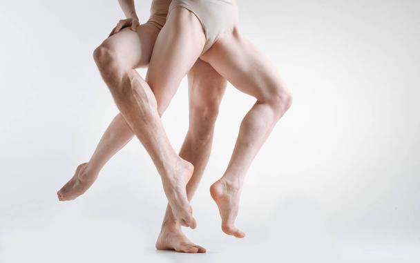 Muscular gymnasts legs demonstrating elegance in the studio - 写真・画像