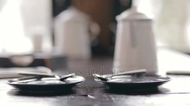 Two women put a cup of tea at same time in cafe - cropped video - Πλάνα, βίντεο