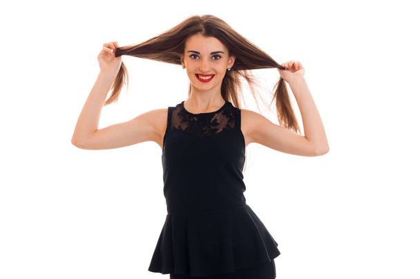 Happy young girl in black dress looking and smiling on camera isolated  white background in studio - Foto, afbeelding