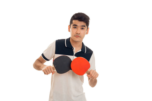 young brunette man playing ping-pong isolated on white background in studio - Foto, Imagen