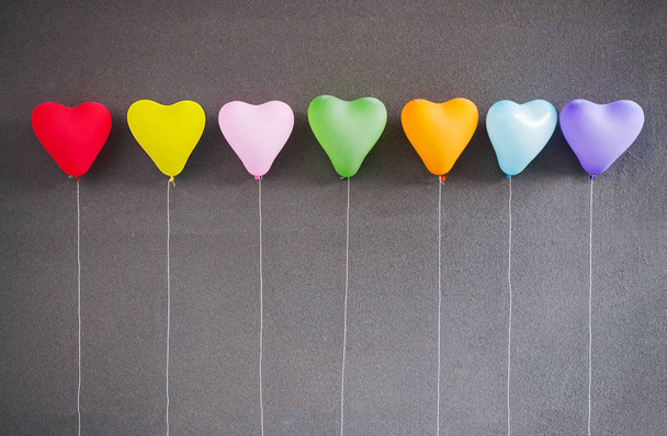 Multicolor balloons heart shape on grey background.  - Φωτογραφία, εικόνα