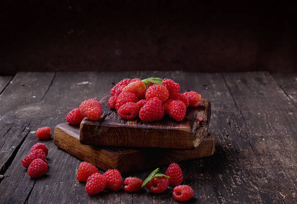 Raspberries on rustic wooden board - Photo, Image