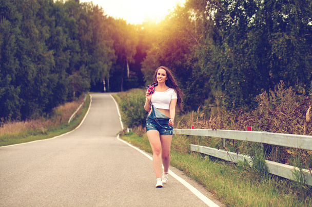 Young beautiful brown haired woman in blue jeans  - Valokuva, kuva