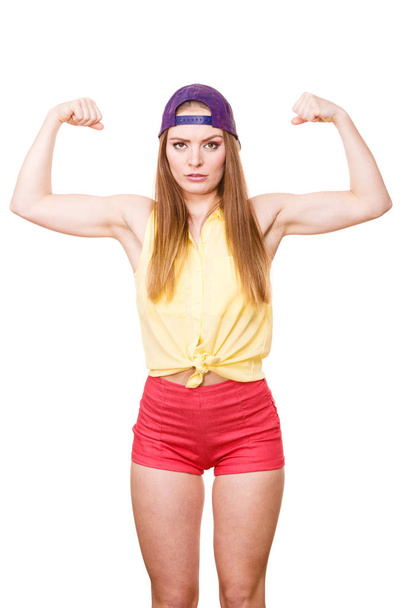Woman casual style showing off muscles biceps  - Фото, изображение