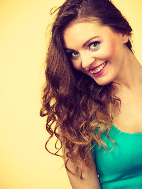 Portrait, young woman wearing colorful makeup and blue top - Foto, afbeelding