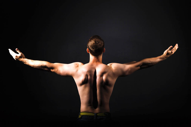 Rear view of healthy muscular young man  - Фото, изображение