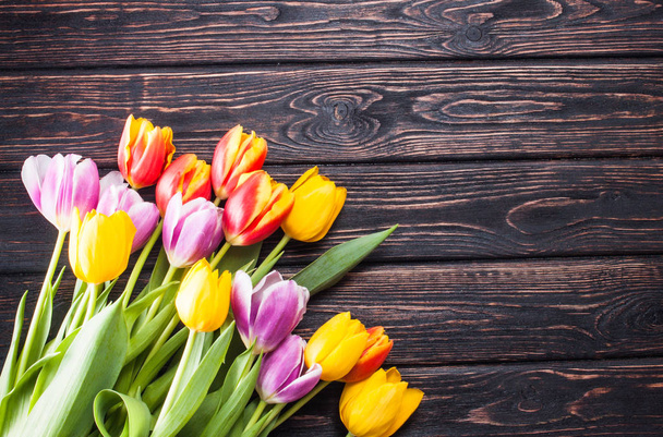 Colored fresh tulip on wood desk  - Valokuva, kuva