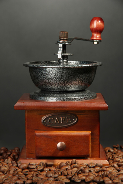 Coffee grinder with coffee beans on grey background - Fotoğraf, Görsel