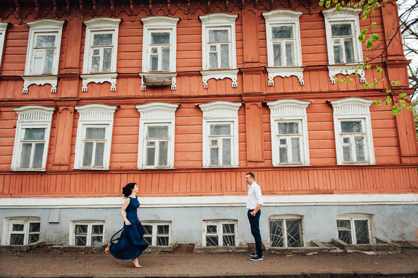 Young couple walking at old wooden house - Fotografie, Obrázek