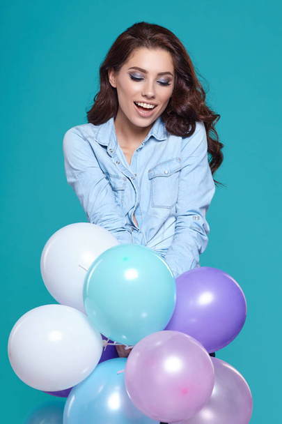 Young pretty woman with colored balloons - 写真・画像