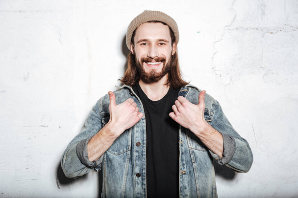 Happy bearded hipster man make thumbs up gesture. - 写真・画像