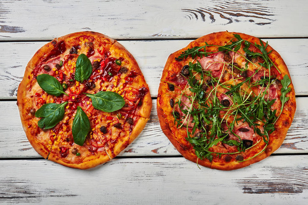 Two pizzas on wooden background. - Photo, Image