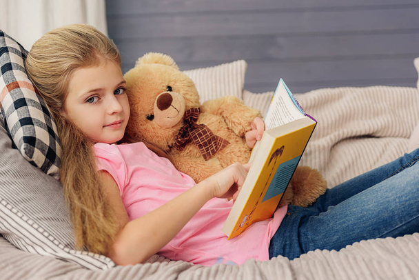 Pretty girl reading story at home - Foto, Imagen