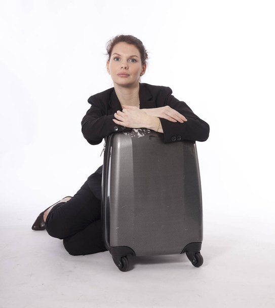 Young businesswoman with suitcase isolated on white background - Fotografie, Obrázek
