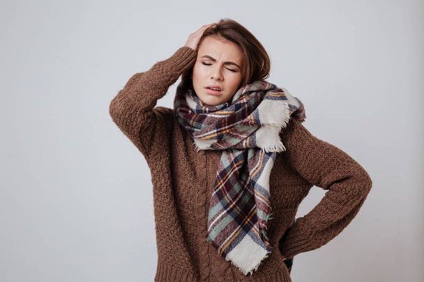 Pensive woman in sweater and scarf - Foto, afbeelding